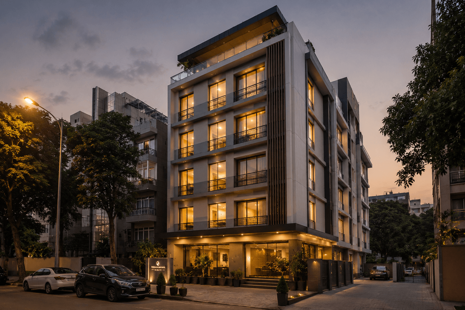 Compact boutique hotel building at dusk in an urban Gurgaon corridor — hospitality development and management.